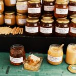 Jars of Swedish honey displayed at a market in Jönköping, Sweden, showcasing a variety of flavors.